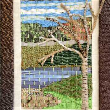 Magazine paper and wool weaving in frame with pipe cleaner tree