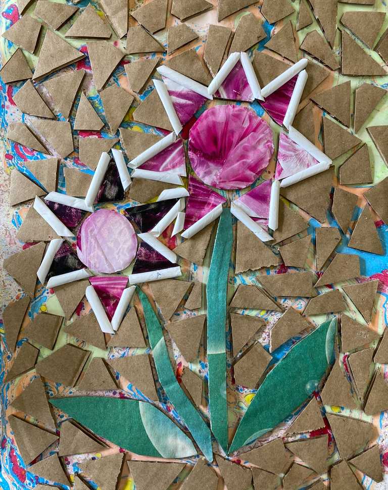 Flower mosaic design using recycled cardboard and magazines on marbled base