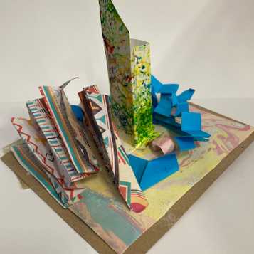 Paper sculpture using marbled paper, brusho sprayed paper and origami paper