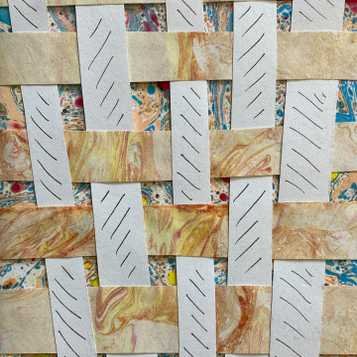Weaving using marbled paper and white paper with mark making